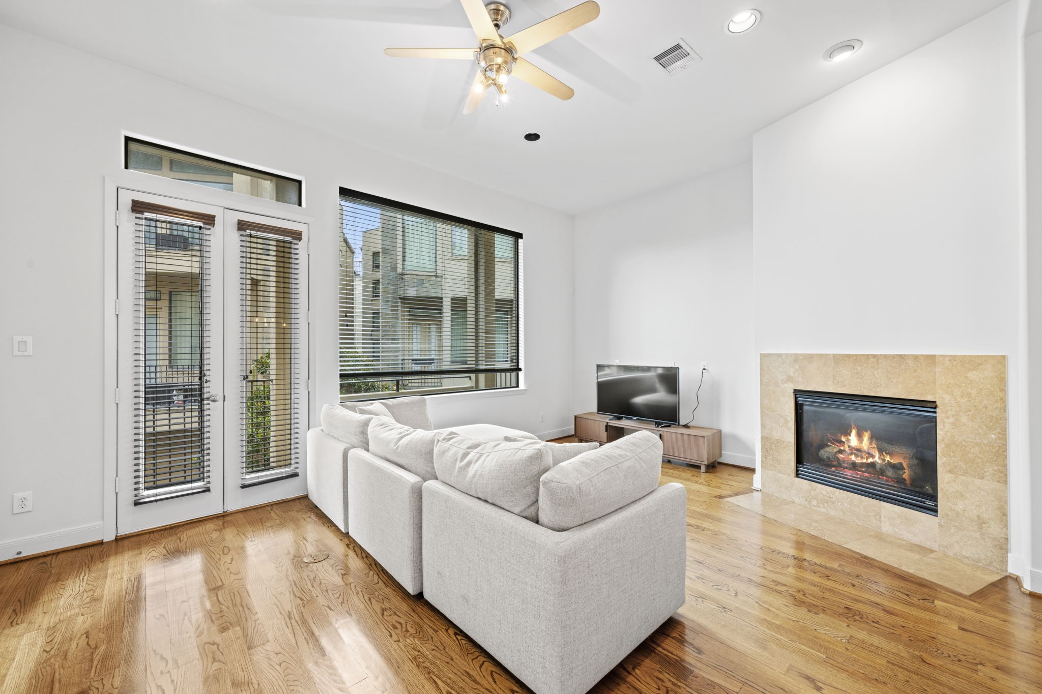 2413 Ralph Street, Unit 9 Houston, TX 77006 - Photo 2 of 19 The large living room space features large windows to allow for natural light, french doors leading to your private balcony and a gas log fireplace.