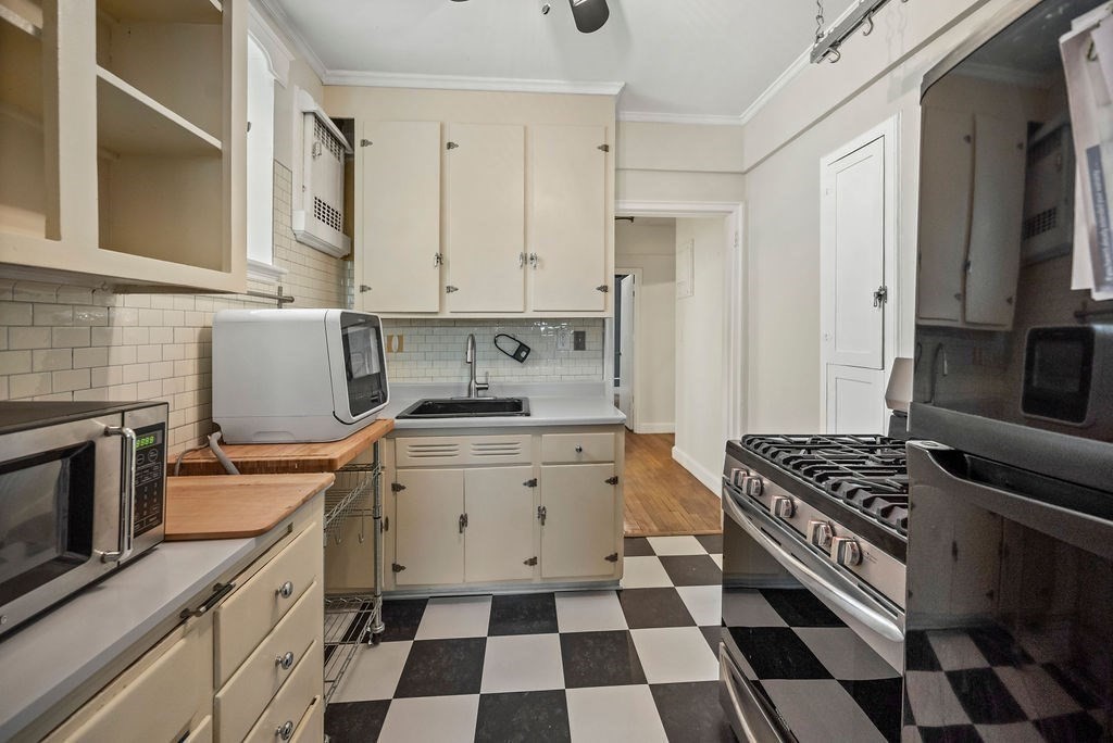 56 Elm Street, Unit 1 Worcester, MA 01609 - Photo 11 of 20 a kitchen with a stove a sink and a refrigerator