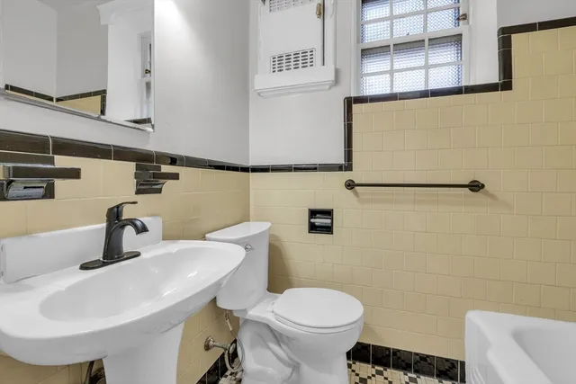 a picture of a bench in front of a wall