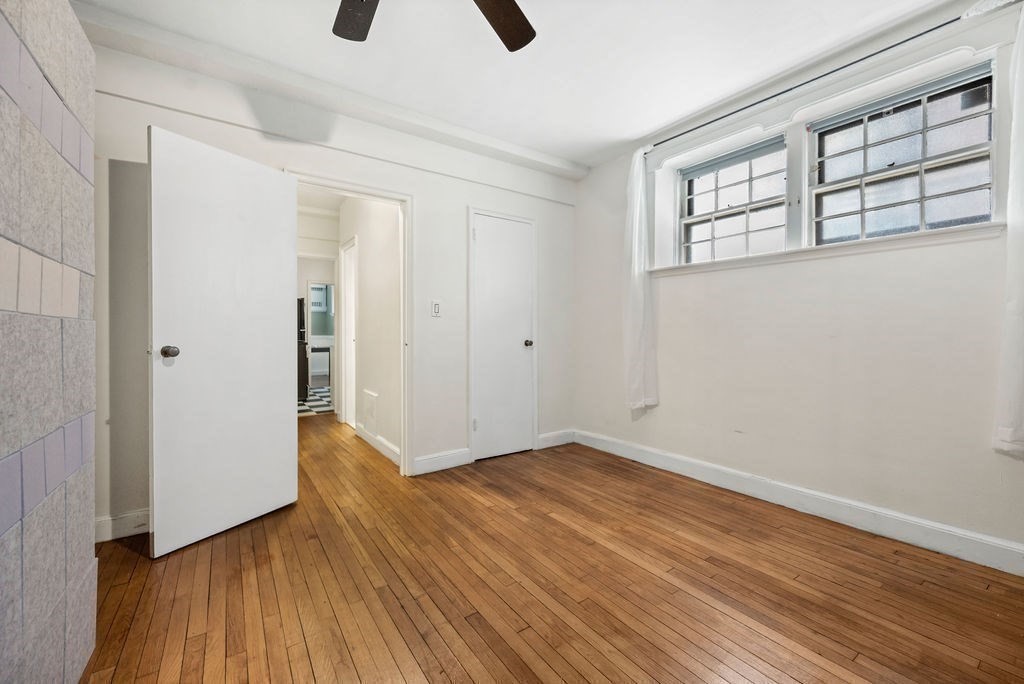 56 Elm Street, Unit 1 Worcester, MA 01609 - Photo 7 of 20 a view of an empty room with wooden floor and a window