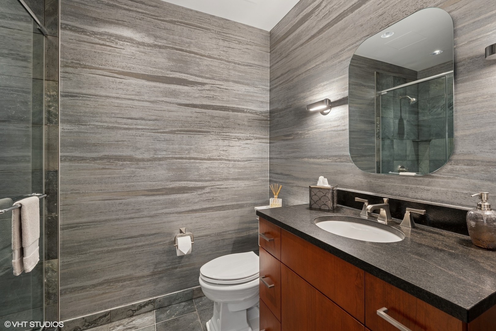 401 North Wabash Avenue, Unit 49G Chicago, IL 60611 - Photo 17 of 60 a bathroom with a granite countertop sink toilet and mirror