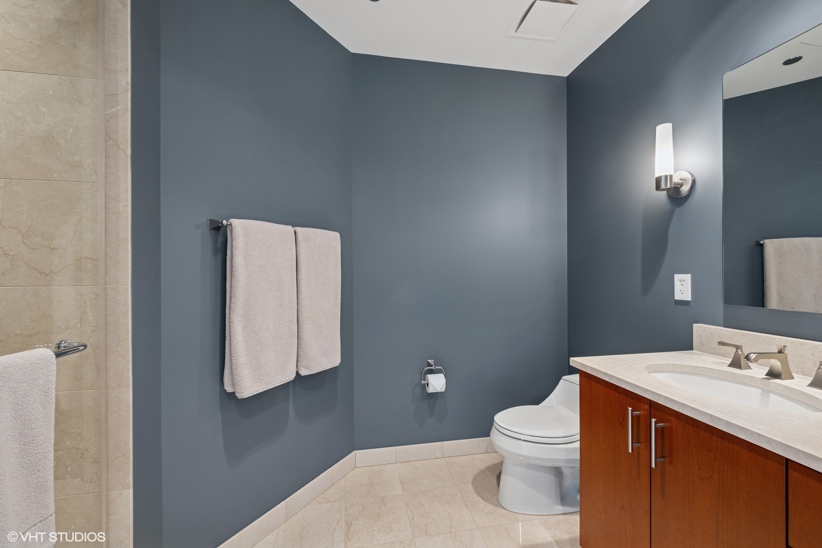 401 North Wabash Avenue, Unit 49G Chicago, IL 60611 - Photo 19 of 60 a bathroom with a toilet sink vanity and mirror