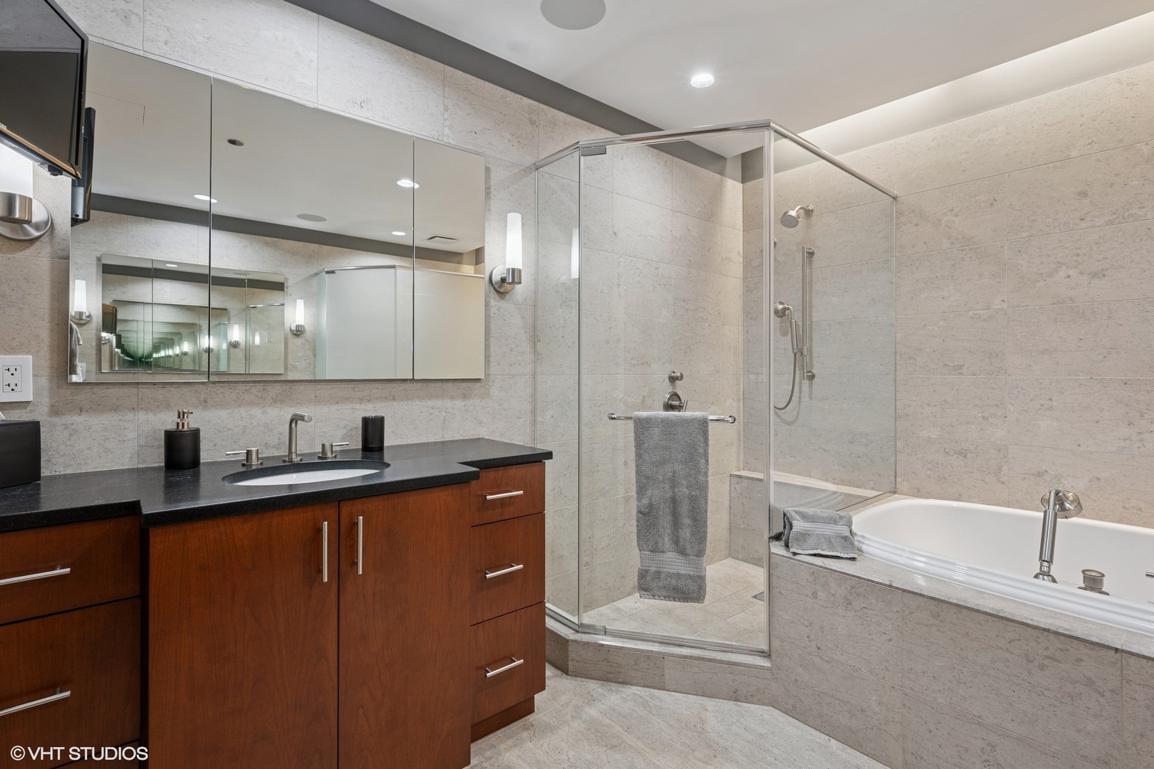 401 North Wabash Avenue, Unit 49G Chicago, IL 60611 - Photo 22 of 60 a bathroom with a granite countertop sink mirror toilet and bathtub