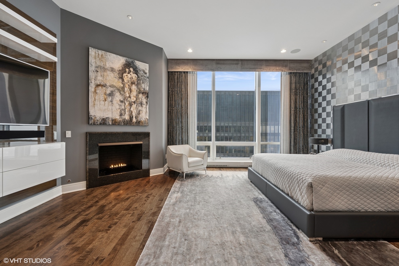 401 North Wabash Avenue, Unit 49G Chicago, IL 60611 - Photo 24 of 60 a spacious bedroom with a bed and a fireplace
