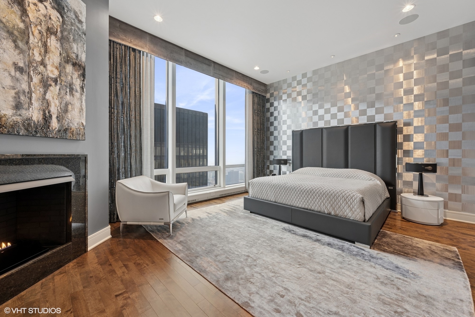 401 North Wabash Avenue, Unit 49G Chicago, IL 60611 - Photo 27 of 60 a spacious bedroom with a large bed and a fireplace