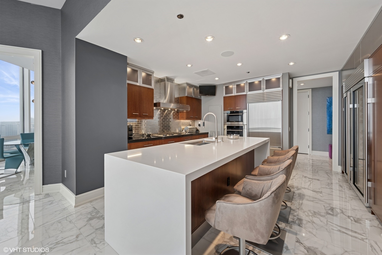 401 North Wabash Avenue, Unit 49G Chicago, IL 60611 - Photo 36 of 60 a kitchen with kitchen island stainless steel appliances a sink and counter space