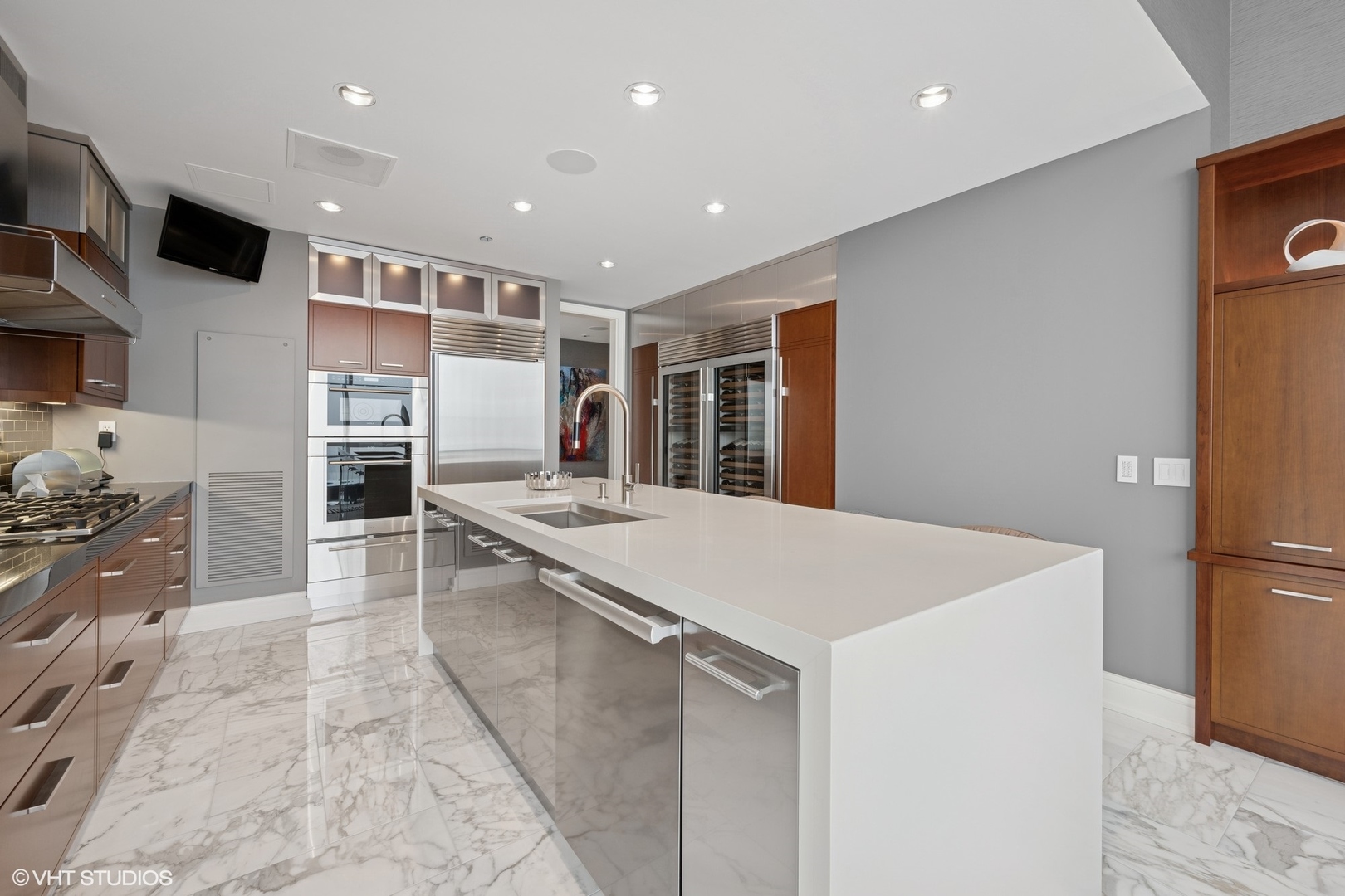 401 North Wabash Avenue, Unit 49G Chicago, IL 60611 - Photo 37 of 60 a kitchen with stainless steel appliances kitchen island granite countertop a refrigerator and a sink