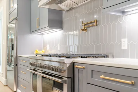 a view of a kitchen with a stove top oven