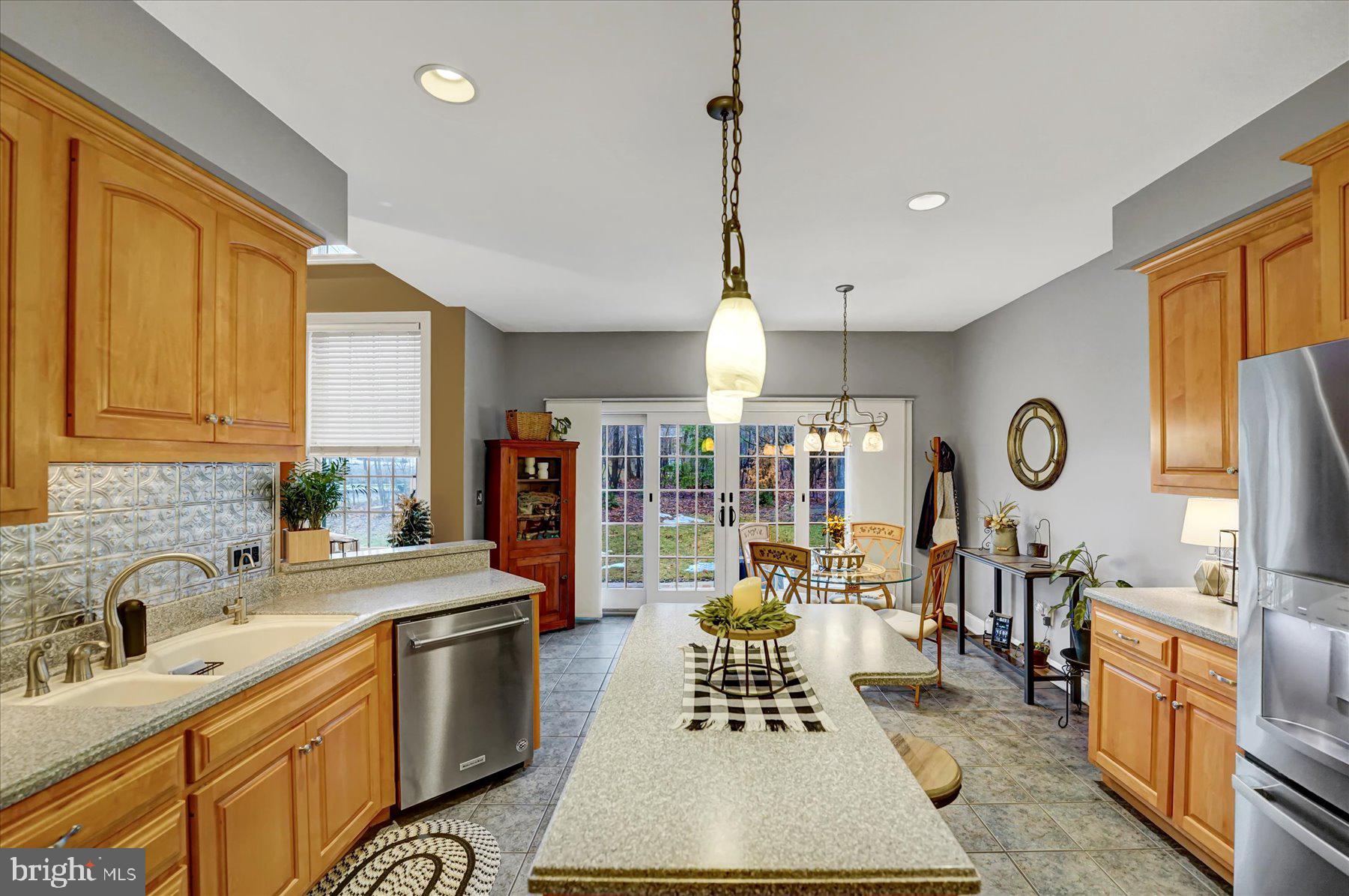 503 Robin Road Bellefonte, PA 16823 - Photo 14 of 72 a large kitchen with stainless steel appliances granite countertop a stove a sink dishwasher a dining table and chairs with wooden floor