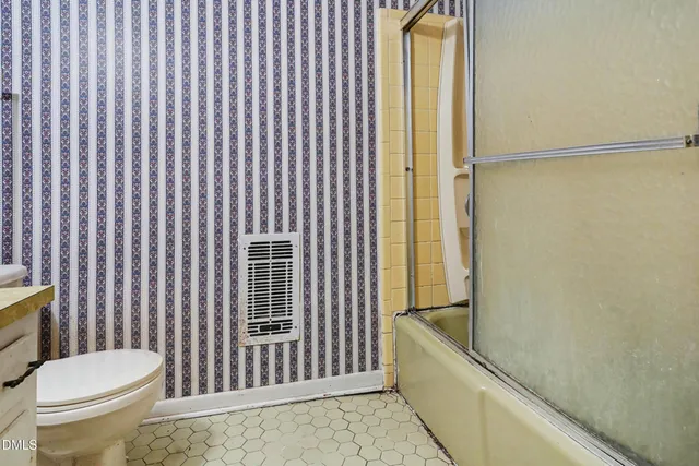 a spacious bedroom with a bed and a table