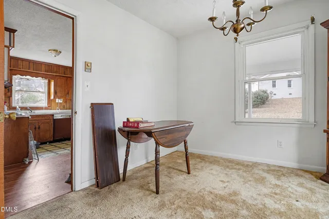 a view of a dining room with furniture and chandelier