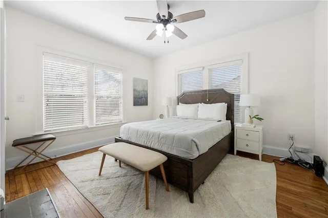 a spacious bedroom with a bed and a chandelier
