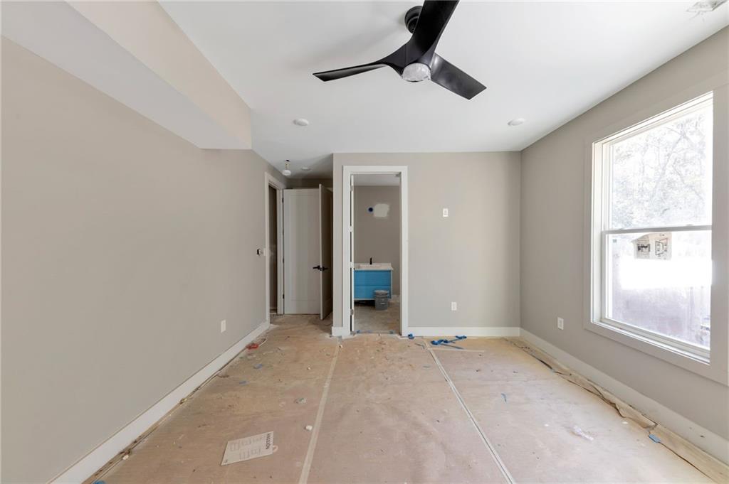1690 Adams Drive Southwest Atlanta, GA 30311 - Photo 19 of 35 a view of an empty room with window and chandelier fan