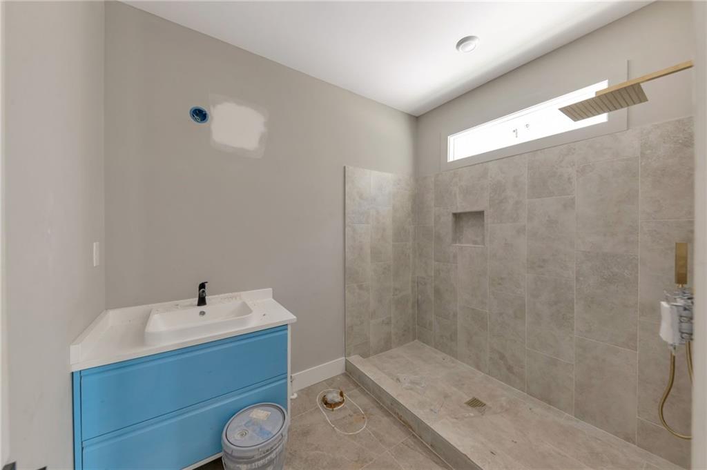 1690 Adams Drive Southwest Atlanta, GA 30311 - Photo 20 of 35 a bathroom with a sink toilet and shower