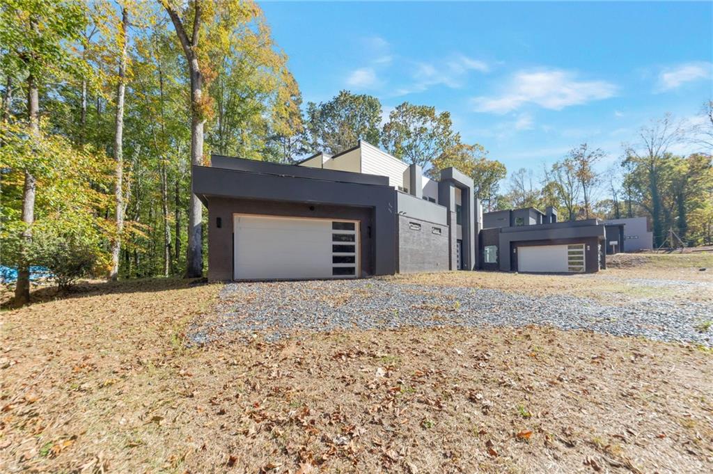 1690 Adams Drive Southwest Atlanta, GA 30311 - Photo 2 of 35 a front view of a house with a yard and garage