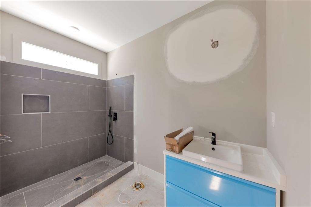1690 Adams Drive Southwest Atlanta, GA 30311 - Photo 22 of 35 a bathroom with a tub sink and shower