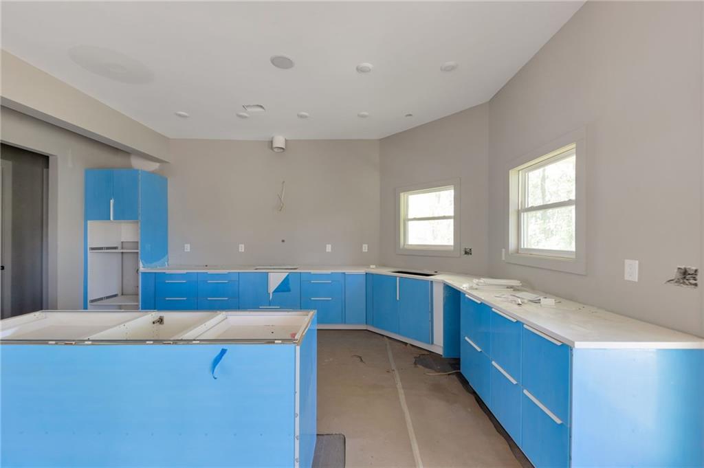 1690 Adams Drive Southwest Atlanta, GA 30311 - Photo 10 of 35 a kitchen with stainless steel appliances granite countertop a sink and a stove