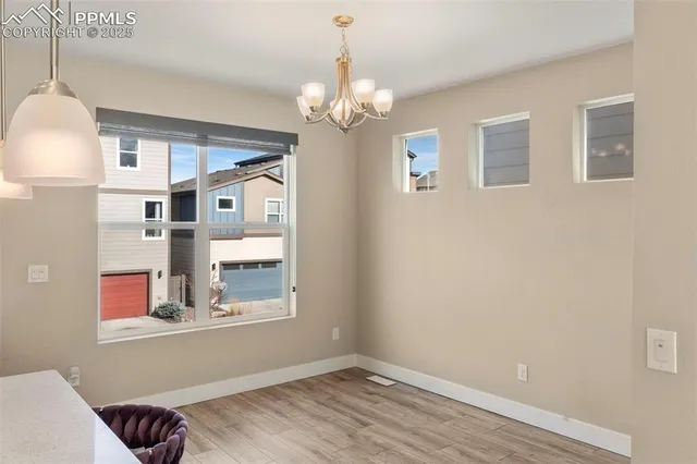 a view of livingroom with chandelier and wooden floor