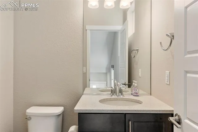 a bathroom with a sink toilet and mirror