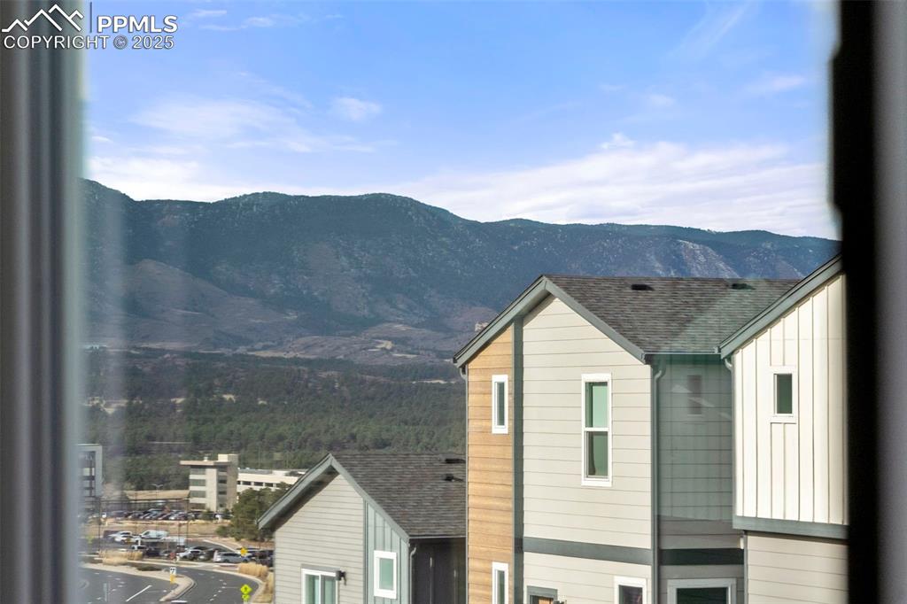 1367 Plentiful Drive Colorado Springs, CO 80921 - Photo 24 of 28 a view of house with a yard and a large tree