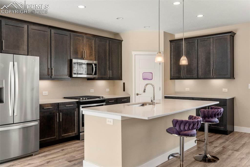 1367 Plentiful Drive Colorado Springs, CO 80921 - Photo 5 of 28 a kitchen with stainless steel appliances granite countertop a refrigerator stove microwave and sink