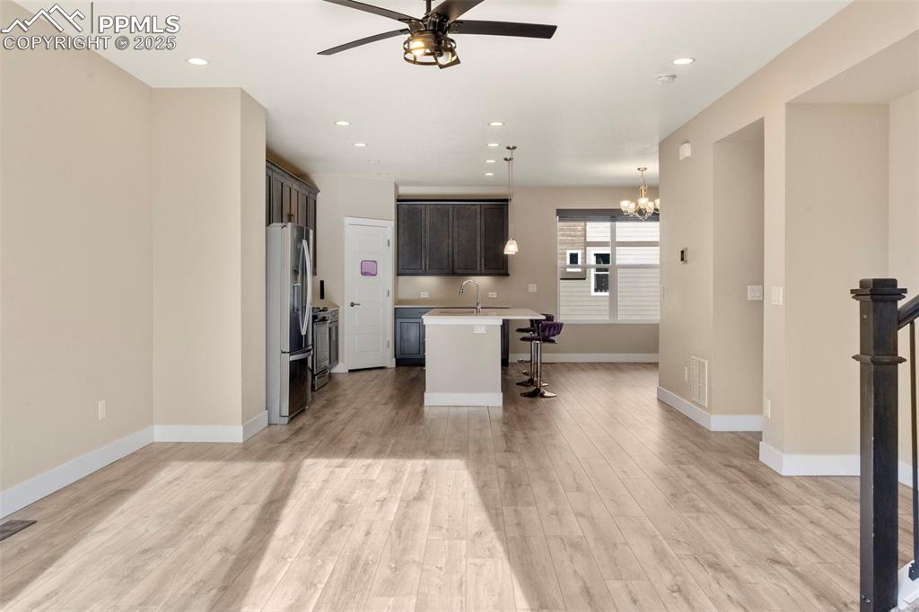 1367 Plentiful Drive Colorado Springs, CO 80921 - Photo 8 of 28 a living room with stainless steel appliances furniture a rug and a kitchen view
