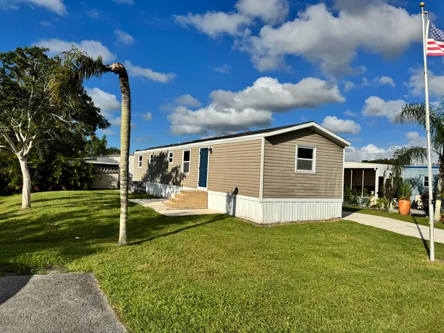 a view of a house with a yard porch and sitting area