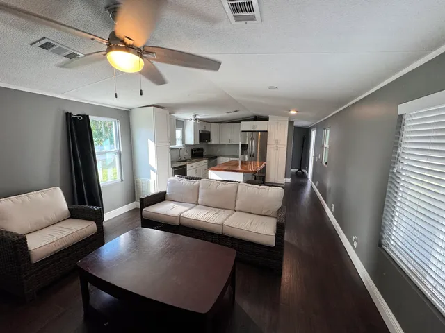 a living room with furniture and a chandelier