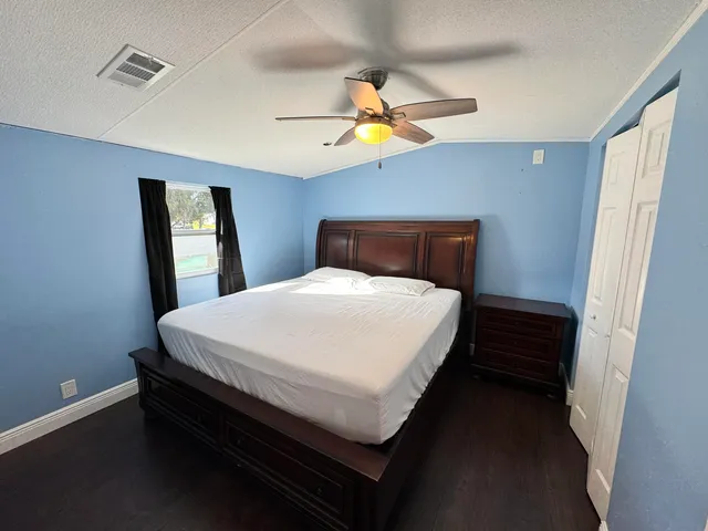a bed sitting in a bedroom next to a window