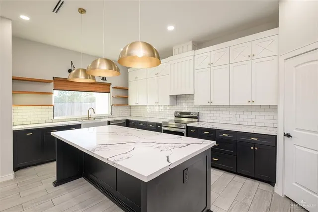 a kitchen with a sink a stove and chairs