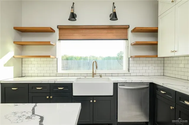 a kitchen with a sink and cabinets