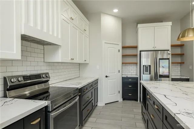 a kitchen with a sink stove and refrigerator