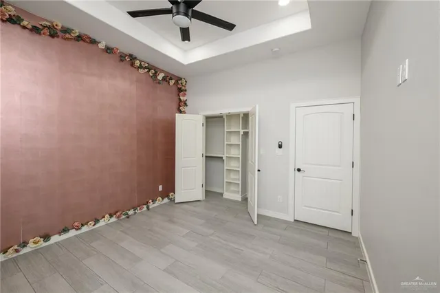 an empty room with a empty space and a ceiling fan