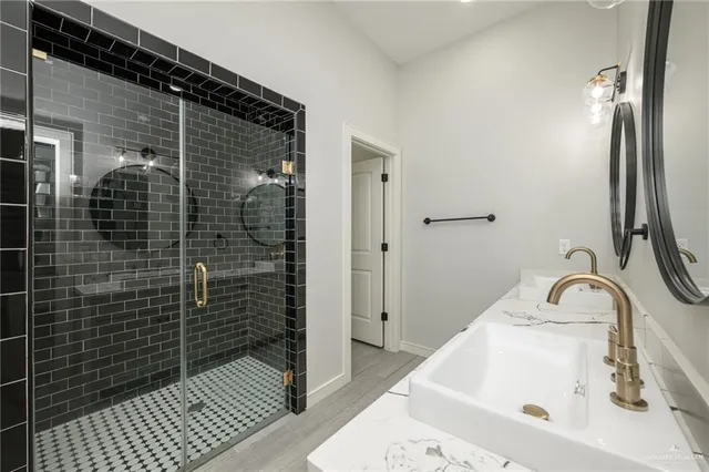 a bathroom with a sink and shower