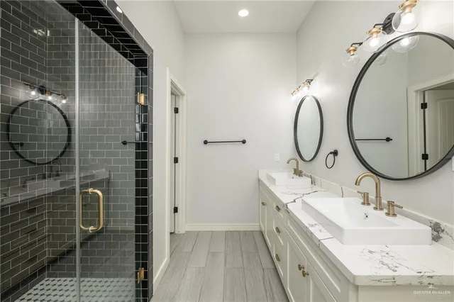 a bathroom with a sink mirror and shower