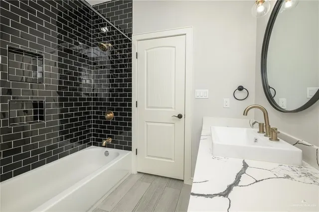 a bathroom with a sink mirror toilet and bathtub