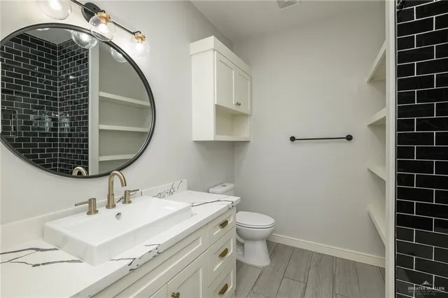 a bathroom with a sink toilet and shower