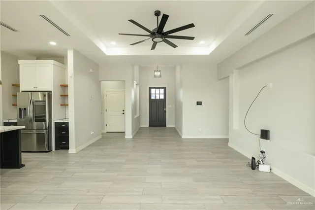 a view of an empty room with a ceiling fan