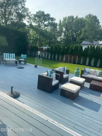 a view of a swimming pool and lounge chairs in back yard