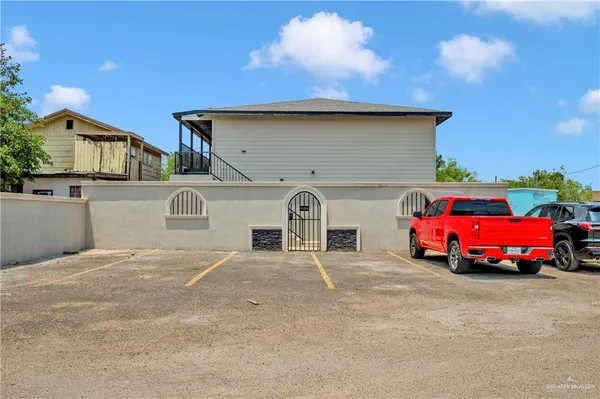 a front view of a house with parking area