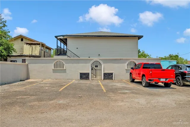 a front view of a house with parking area