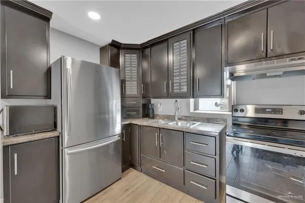 a kitchen with a refrigerator and a sink