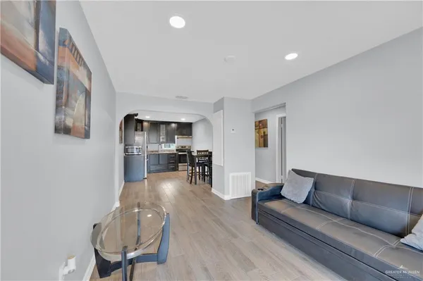 a living room with furniture and wooden floor