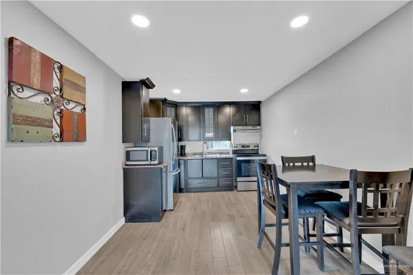 a kitchen with cabinets and stainless steel appliances