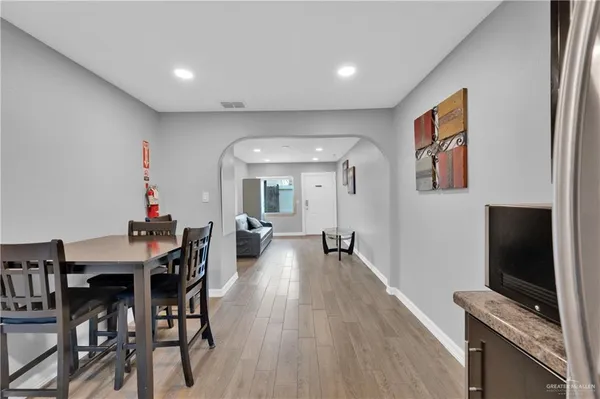 a dining room with furniture and wooden floor