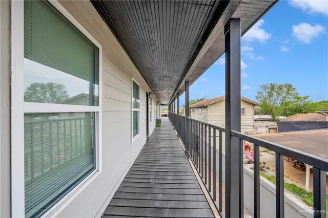 a view of balcony with wooden floor