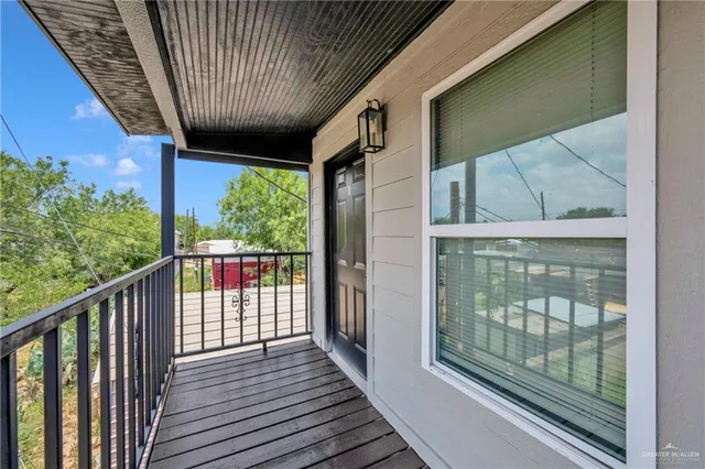 a view of a balcony with wooden floor