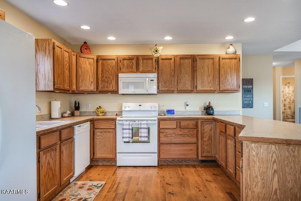 634 Mate Allen Road Red Boiling Springs, TN 37150 - Photo 13 of 38 a kitchen with stainless steel appliances granite countertop a stove top oven a sink and dishwasher with wooden cabinets