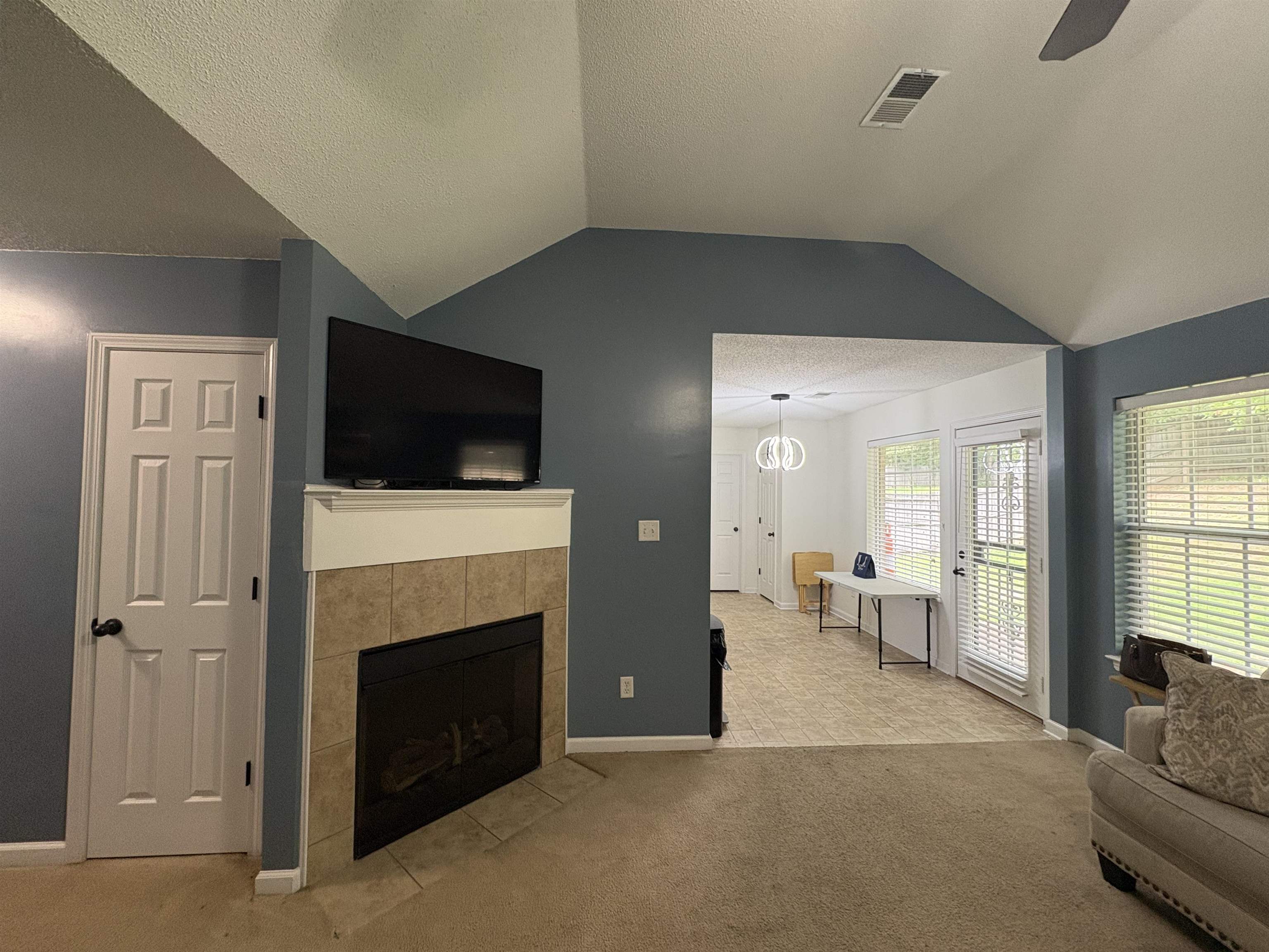 4356 Cedar Hills Road Memphis, TN 38135 - Photo 13 of 29 Living area featuring a gas fireplace with a tiled surround and white mantel