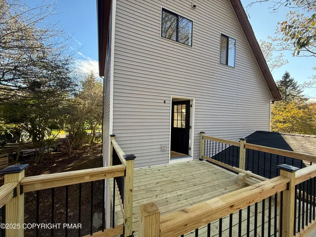 a view of a house with wooden fence